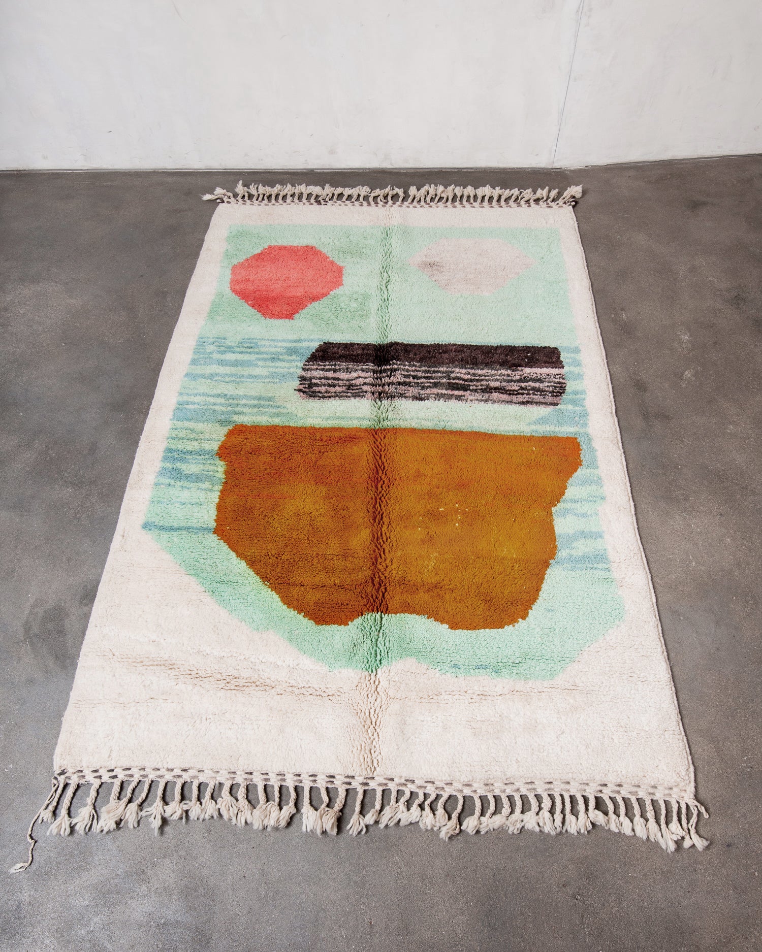 Colorful geometric-patterned rug on a concrete floor
